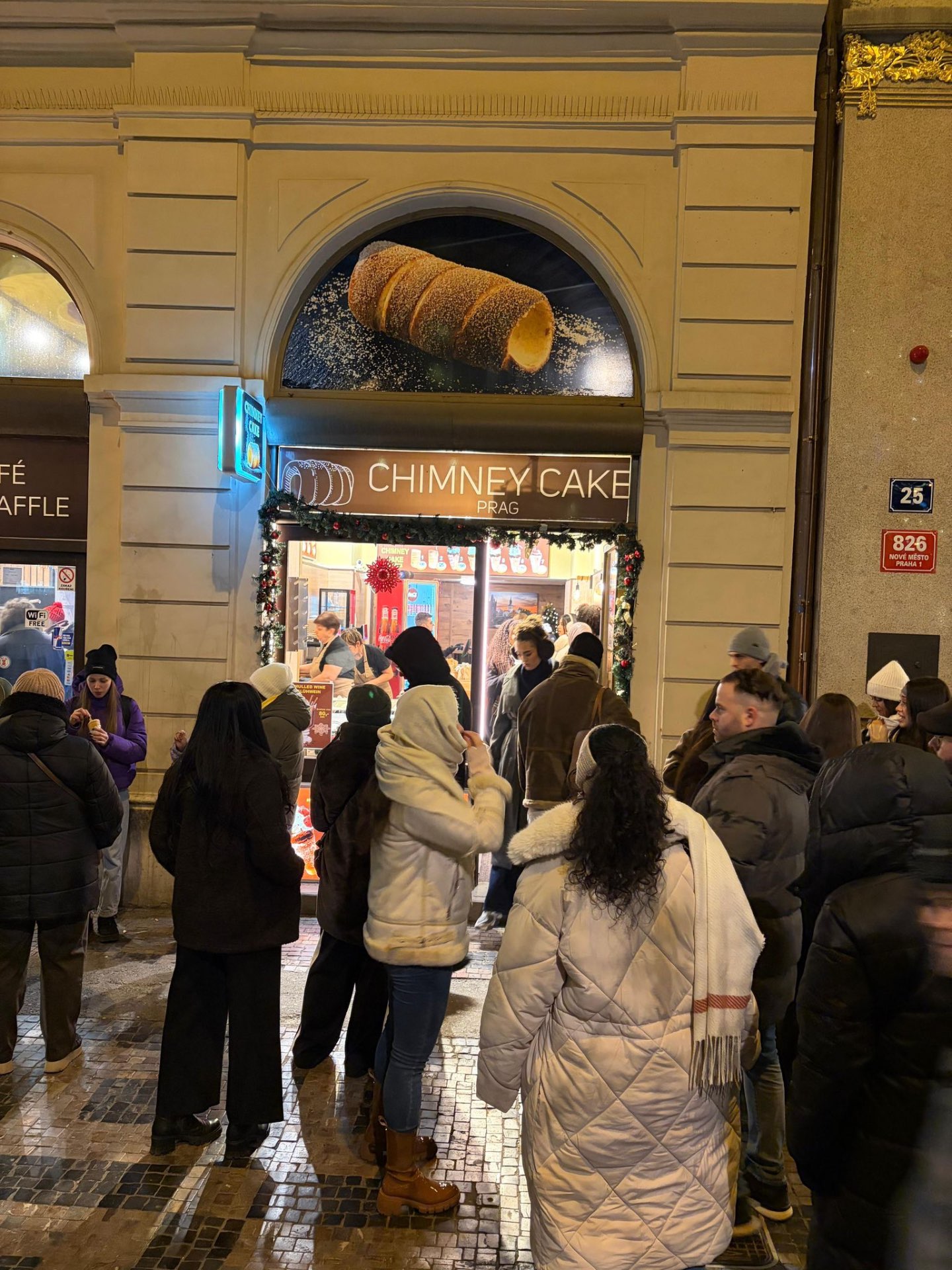 Chimney Cake Prag storefront on a winter evening in Prague
